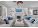 Living room features a fireplace, built-in shelving, and comfortable seating at 321 Commons Walk Cir, Cary, NC 27519