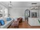Living area with modern lighting adjoins a kitchen featuring island and stainless appliances at 321 Commons Walk Cir, Cary, NC 27519