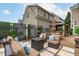 Expansive brick patio showcasing multiple seating areas, a gazebo, and decorative privacy screens with lush greenery at 321 Commons Walk Cir, Cary, NC 27519