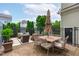 Spacious brick patio featuring a large dining table, umbrella, and lounge area surrounded by decorative fencing and greenery at 321 Commons Walk Cir, Cary, NC 27519