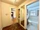 Bright bathroom featuring a large window and classic black and white tile flooring at 3810 Pendergrass St, Durham, NC 27704