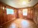 Cozy bedroom with wood paneled walls and a unique parquet floor at 3810 Pendergrass St, Durham, NC 27704