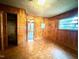Bedroom features a parquet floor, wood paneled walls, and a built-in closet at 3810 Pendergrass St, Durham, NC 27704
