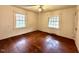 The bright bedroom features wood floors and windows at 3810 Pendergrass St, Durham, NC 27704
