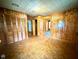 Spacious bedroom features a parquet floor, wood paneled walls, and a built-in closet at 3810 Pendergrass St, Durham, NC 27704