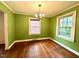 Bright dining room featuring green walls, hardwood floors, and natural light at 3810 Pendergrass St, Durham, NC 27704