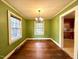 Dining room featuring hardwood floors, two windows, and a hanging chandelier at 3810 Pendergrass St, Durham, NC 27704