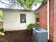 Exterior view of a brick and vinyl sided home with a modern AC unit at 3810 Pendergrass St, Durham, NC 27704