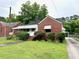 Front exterior view of the brick and siding home with a small yard at 3810 Pendergrass St, Durham, NC 27704