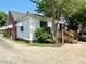 Side exterior view showing the brick and siding and small entry deck at 3810 Pendergrass St, Durham, NC 27704