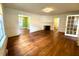 Open-concept living room with hardwood floors, fireplace, and connections to other rooms at 3810 Pendergrass St, Durham, NC 27704