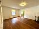 Living room with hardwood floors, a large window, and plenty of natural light at 3810 Pendergrass St, Durham, NC 27704