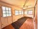 Sun room with wooden floors, multiple windows, and a ceiling fan at 3810 Pendergrass St, Durham, NC 27704