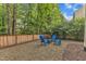 Backyard gravel patio and chairs, creating a cozy gathering space with an outdoor firepit at 4028 Winecott Dr, Apex, NC 27502