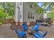 Private backyard with gravel patio and firepit, framed by mature trees and privacy fence at 4028 Winecott Dr, Apex, NC 27502