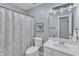 Cozy bathroom featuring a vanity with a sink, toilet, and shower with curtain at 4028 Winecott Dr, Apex, NC 27502