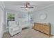 Charming Bedroom with white crib, accent furniture and soft, neutral decor at 4028 Winecott Dr, Apex, NC 27502
