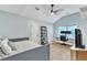 Bright bedroom with a bed, white desk, black shelving and a ceiling fan at 4028 Winecott Dr, Apex, NC 27502