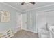 A well-lit bedroom with a neutral color scheme, closet, and doorway at 4028 Winecott Dr, Apex, NC 27502