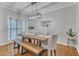Stylish dining room featuring a modern light fixture, hardwood flooring, and elegant decor, perfect for gatherings at 4028 Winecott Dr, Apex, NC 27502