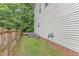 View of a home's exterior, with a fenced yard and utility infrastructure visible at 4028 Winecott Dr, Apex, NC 27502