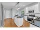 Modern kitchen featuring stainless steel appliances, island, and bright lighting at 4028 Winecott Dr, Apex, NC 27502