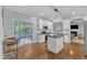 Spacious kitchen with sliding glass doors to deck, island, and gas range at 4028 Winecott Dr, Apex, NC 27502