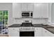 Close up of gas range and kitchen with white subway tile backsplash at 4028 Winecott Dr, Apex, NC 27502