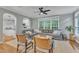 Inviting living room featuring hardwood floors, neutral tones, and a seamless transition to the adjacent kitchen space at 4028 Winecott Dr, Apex, NC 27502