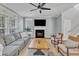 Bright living room with large windows, fireplace, and contemporary decor at 4028 Winecott Dr, Apex, NC 27502