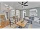 Spacious living room with hardwood floors, a modern ceiling fan, and arched doorways leading to other rooms in the house at 4028 Winecott Dr, Apex, NC 27502
