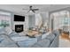 Comfortable living room with a fireplace, ceiling fan, and stylish furniture at 4028 Winecott Dr, Apex, NC 27502