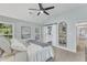 Light-filled main bedroom features barn door leading to bathroom and is decorated in light, neutral tones at 4028 Winecott Dr, Apex, NC 27502