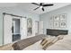 Main bedroom features barn door to bathroom, dark dresser, ceiling fan and light blue walls at 4028 Winecott Dr, Apex, NC 27502