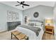 Main bedroom boasts ceiling fan, and light blue paint with neutral carpet and contemporary furnishings at 4028 Winecott Dr, Apex, NC 27502