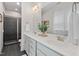 Modern bathroom with double sinks, sleek gray cabinets, and a glass-enclosed shower at 415 Dupree St, Durham, NC 27707