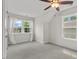 Bright bedroom with white walls, plush carpet, and sunlit windows at 415 Dupree St, Durham, NC 27707