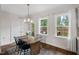 Cozy dining area with natural light and a view of the backyard, featuring white curtains at 415 Dupree St, Durham, NC 27707