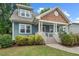 A quaint blue home showcases a welcoming porch, complete with a white railing and inviting front steps at 415 Dupree St, Durham, NC 27707