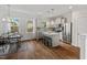 Charming kitchen and dining area featuring stainless appliances, an island, and large windows at 415 Dupree St, Durham, NC 27707