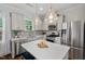 Well-lit kitchen with stainless steel appliances, light countertops, and stylish hanging lights at 415 Dupree St, Durham, NC 27707