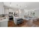 Open-concept kitchen featuring a central island, stainless steel appliances, and hardwood floors at 415 Dupree St, Durham, NC 27707