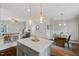 Spacious kitchen with island and stainless steel appliances, open to the dining area and living room at 415 Dupree St, Durham, NC 27707