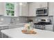 Bright kitchen with quartz countertops, stainless steel appliances and grey backsplash at 415 Dupree St, Durham, NC 27707