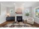 Cozy living room featuring a fireplace, hardwood floors, neutral colored furniture and lots of light at 415 Dupree St, Durham, NC 27707