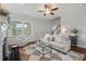 Cozy living room featuring a fireplace, hardwood floors, neutral colored furniture and lots of light at 415 Dupree St, Durham, NC 27707