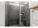 Stylish shower with gray tile, glass door, and modern fixtures at 415 Dupree St, Durham, NC 27707
