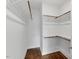 Spacious walk-in closet with built-in shelving and wooden rods for ample storage at 415 Dupree St, Durham, NC 27707