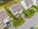 Aerial view of a home showcasing the roof, driveway, fenced backyard, and the trees in the front and back at 4212 Auburn Hills Dr, Raleigh, NC 27616