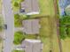 Aerial view shows the fenced backyard, neighboring houses and street at 4212 Auburn Hills Dr, Raleigh, NC 27616